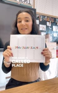 Ashley showing her FREE Place Value Wars game in a IG reel